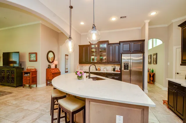 a large kitchen with a table and chairs