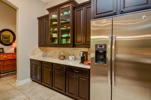 a kitchen with a refrigerator and a sink