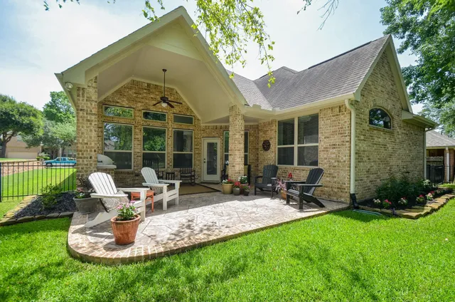 a front view of a house with a garden and patio