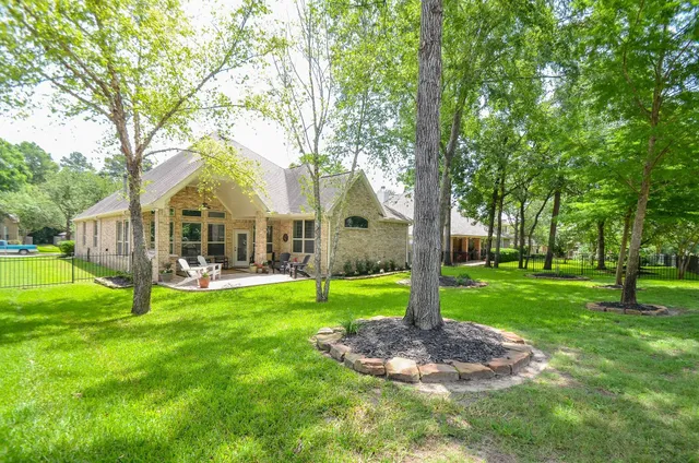 a view of a house with backyard and sitting area