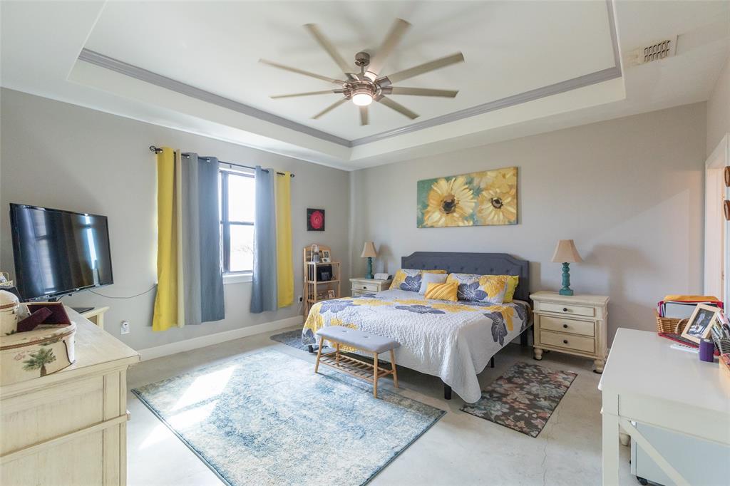 760 Wimberly Road Merkel, TX 79536 - Photo 19 of 35 Tray ceiling with crown molding, ceiling fan with integrated lighting, window with ample natural light, light-toned walls, and durable flooring