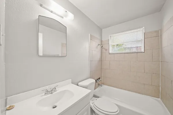 a bathroom with a sink toilet and bathtub