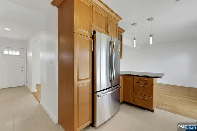 a kitchen with stainless steel appliances a refrigerator and a stove