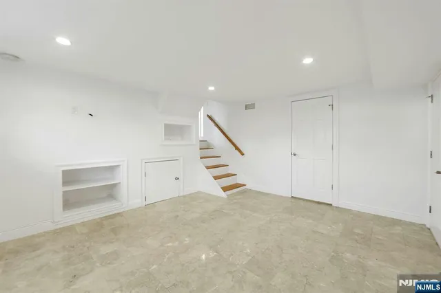 a view of an empty room with stairs and ventilation