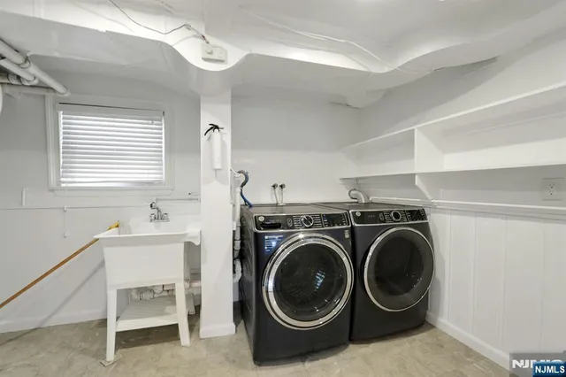 a utility room with sink dryer and washer