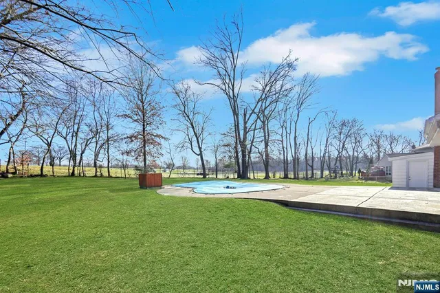 a backyard of apartments with large trees