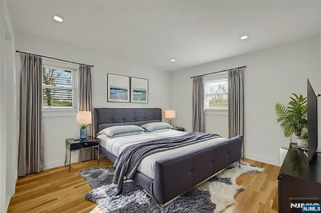 a bed room with a bed and a potted plant