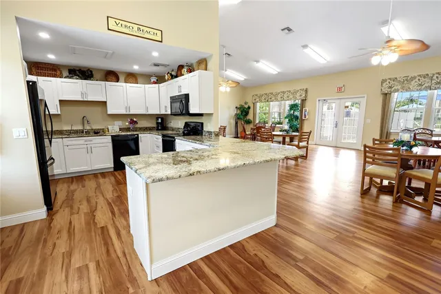 a room with gym equipment and wooden floor