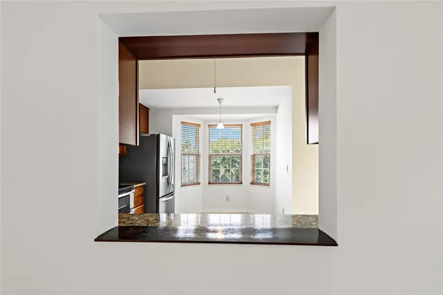 a kitchen with granite countertop a refrigerator and a sink