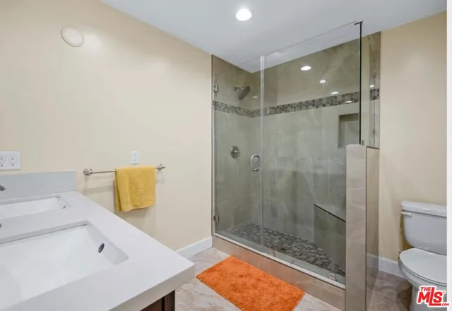 a bathroom with a shower and a toilet