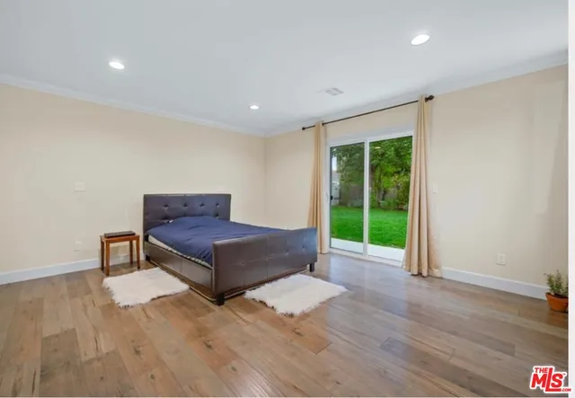 a living room with a bed furniture and a window
