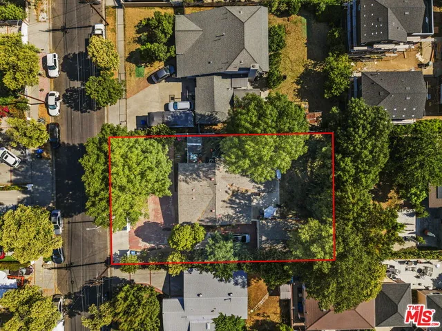 an aerial view of a house with a yard and garden
