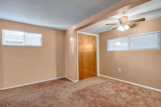 a view of a livingroom with a chandelier fan
