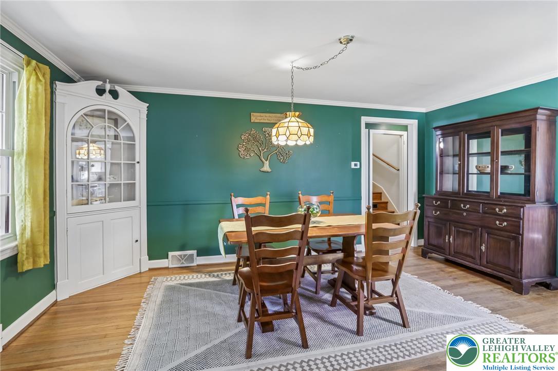974 Juniper Road Hellertown, PA 18055 - Photo 8 of 48 Hardwood floors and crown molding elevate this charming dining space.