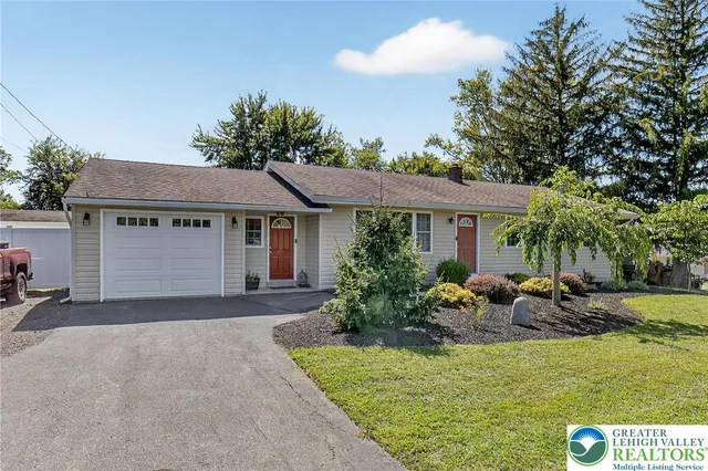 a front view of house with yard outdoor seating and green space