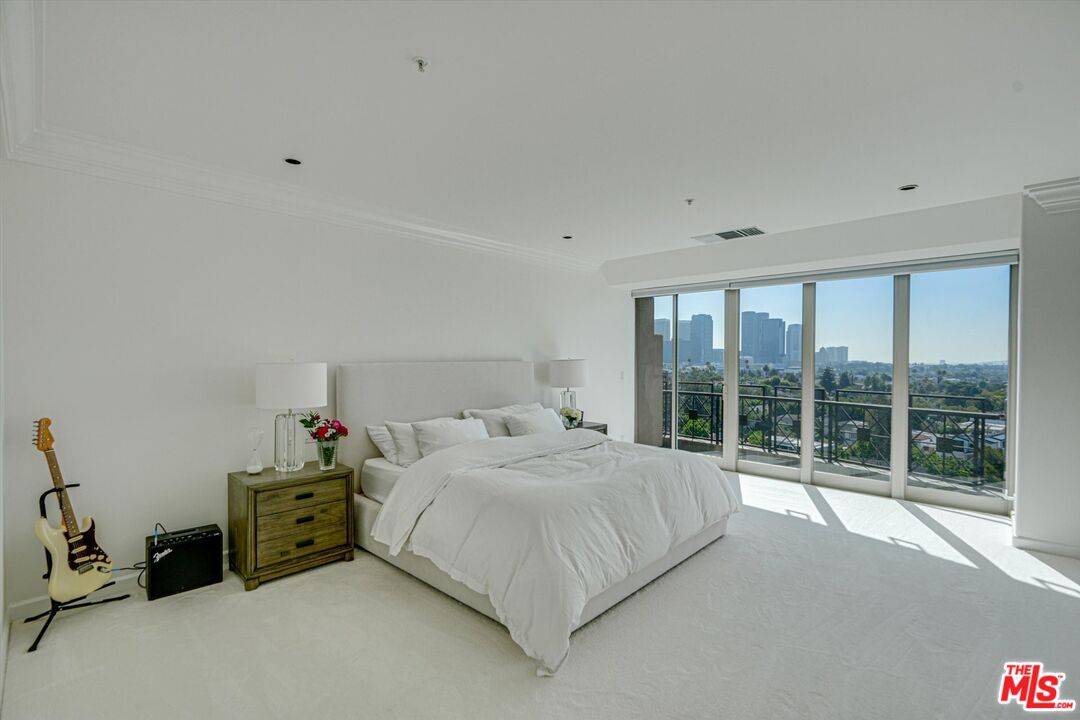 10580 Wilshire Boulevard, Unit 8SW Los Angeles, CA 90024 - Photo 12 of 38 a bedroom with a bed and large window