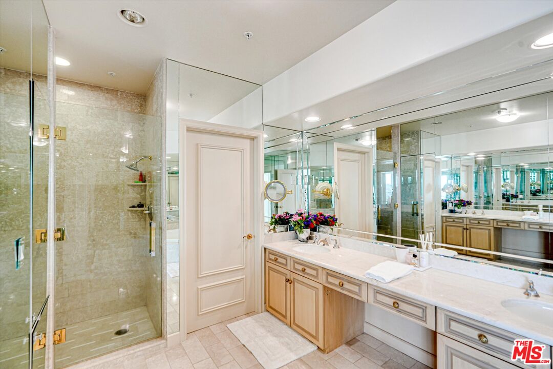 10580 Wilshire Boulevard, Unit 8SW Los Angeles, CA 90024 - Photo 15 of 38 a spacious bathroom with a shower sink and mirror