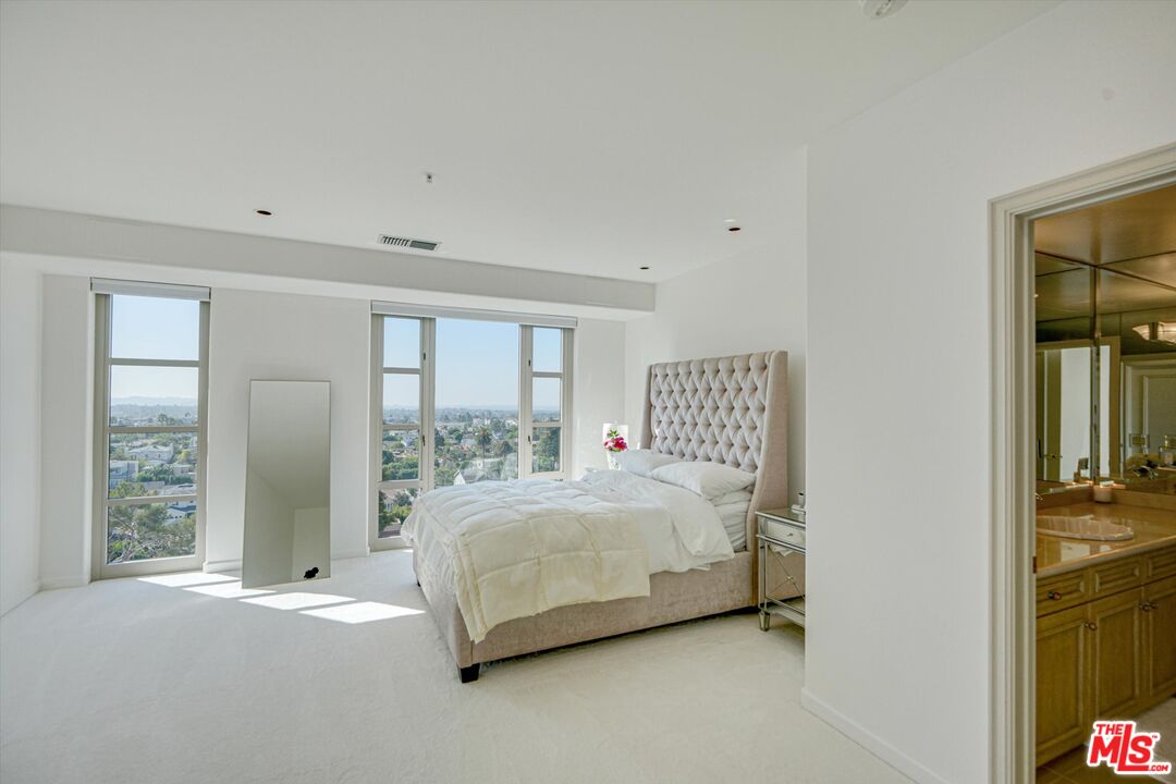 10580 Wilshire Boulevard, Unit 8SW Los Angeles, CA 90024 - Photo 16 of 38 a bedroom with a bed and a large window
