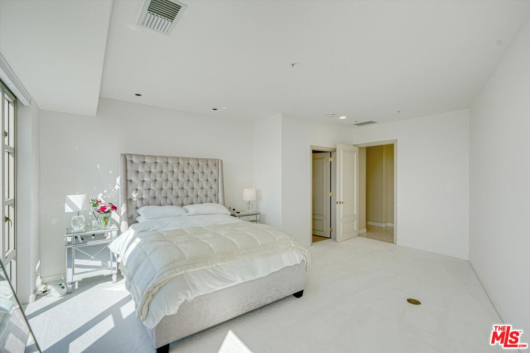 10580 Wilshire Boulevard, Unit 8SW Los Angeles, CA 90024 - Photo 17 of 38 a bedroom with a bed and a window