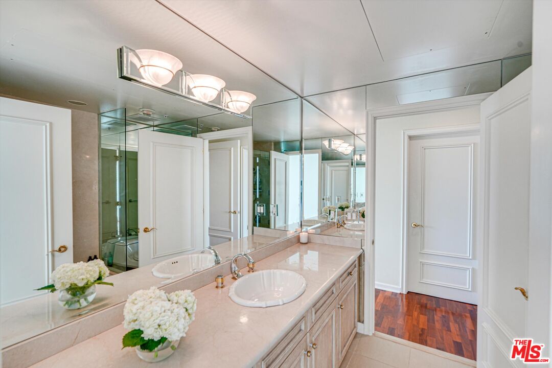 10580 Wilshire Boulevard, Unit 8SW Los Angeles, CA 90024 - Photo 18 of 38 a bathroom with a granite countertop sink and a mirror