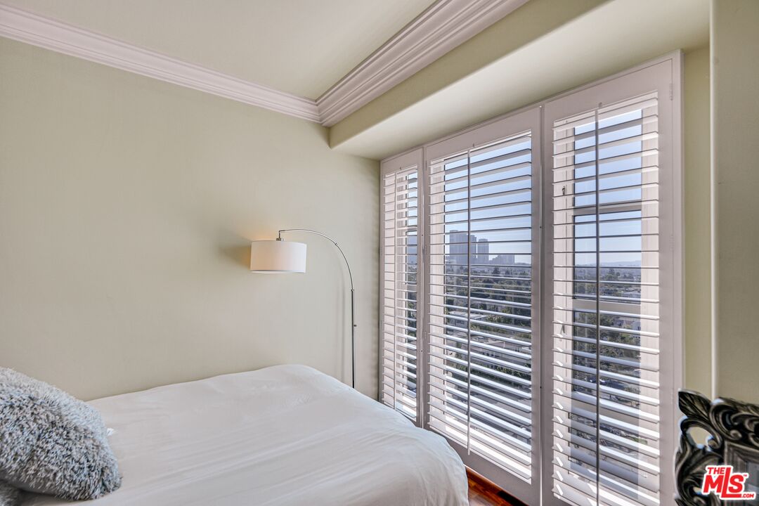 10580 Wilshire Boulevard, Unit 8SW Los Angeles, CA 90024 - Photo 19 of 38 a bedroom with a bed and a window