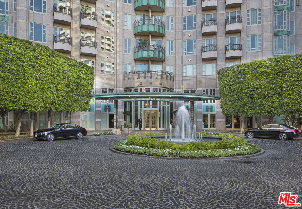 10580 Wilshire Boulevard, Unit 8SW Los Angeles, CA 90024 - Photo 2 of 38 a front view of a building with a garden and plants