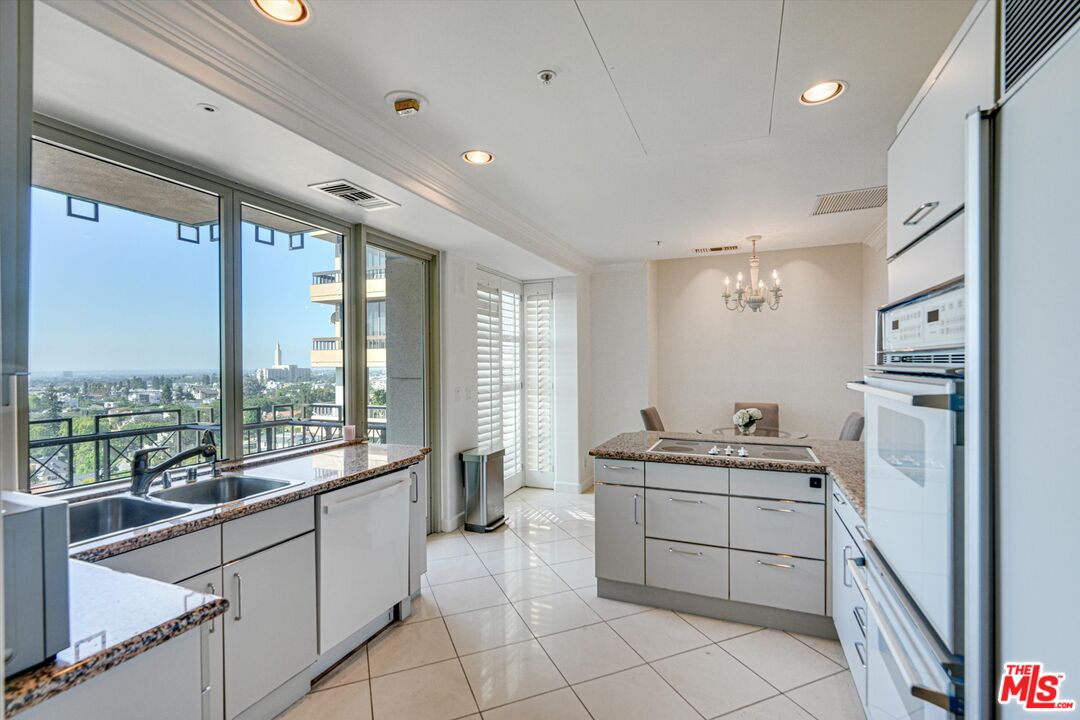 10580 Wilshire Boulevard, Unit 8SW Los Angeles, CA 90024 - Photo 25 of 38 a large white kitchen with a large window