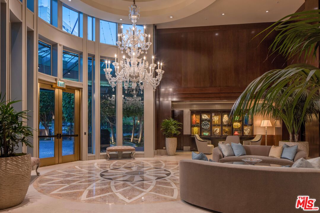 10580 Wilshire Boulevard, Unit 8SW Los Angeles, CA 90024 - Photo 33 of 38 a lobby with a chandelier and living room view