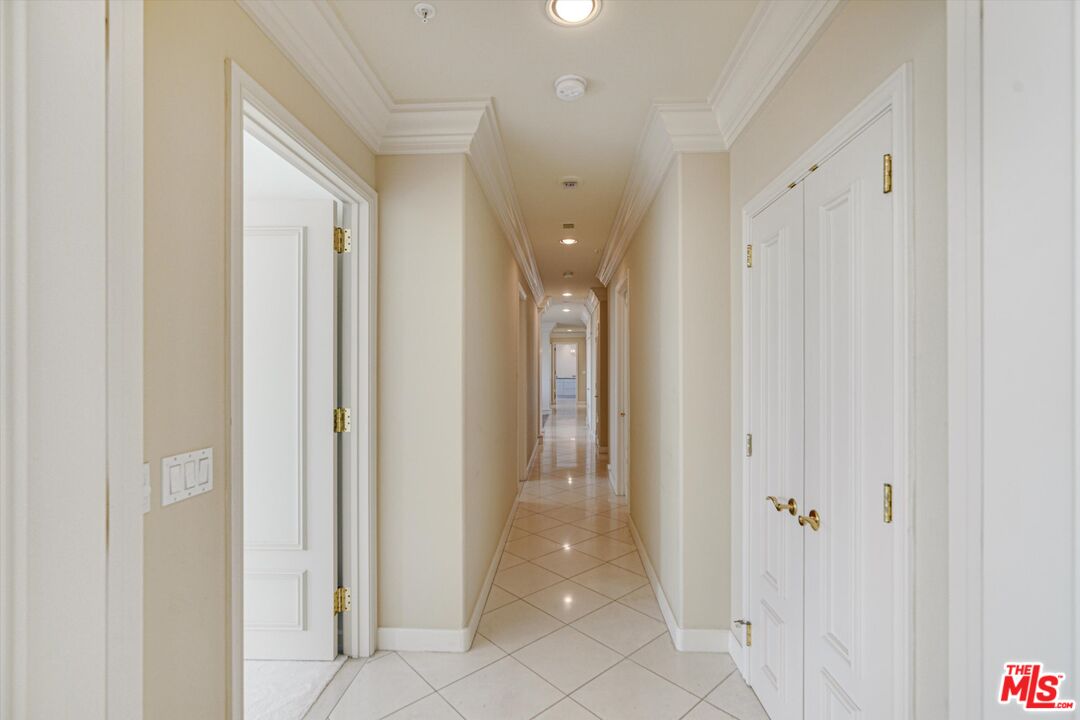10580 Wilshire Boulevard, Unit 8SW Los Angeles, CA 90024 - Photo 10 of 38 a view of a hallway with wooden shelves