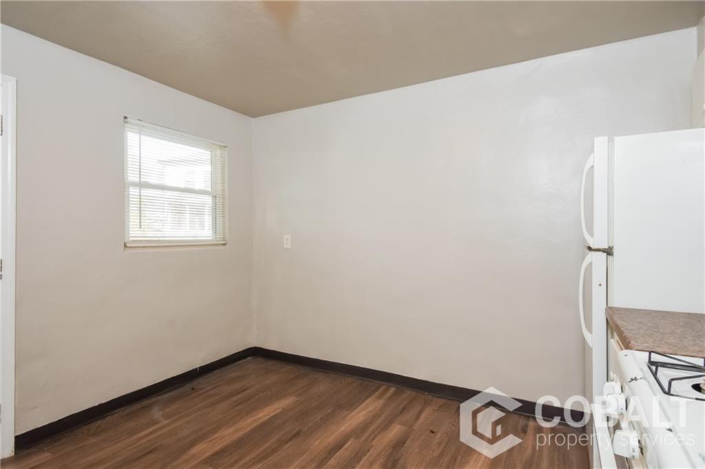 1990 Rockledge Road Northeast, Unit 3 Atlanta, GA 30324 - Photo 4 of 8 a view of a room with wooden floor and white walls