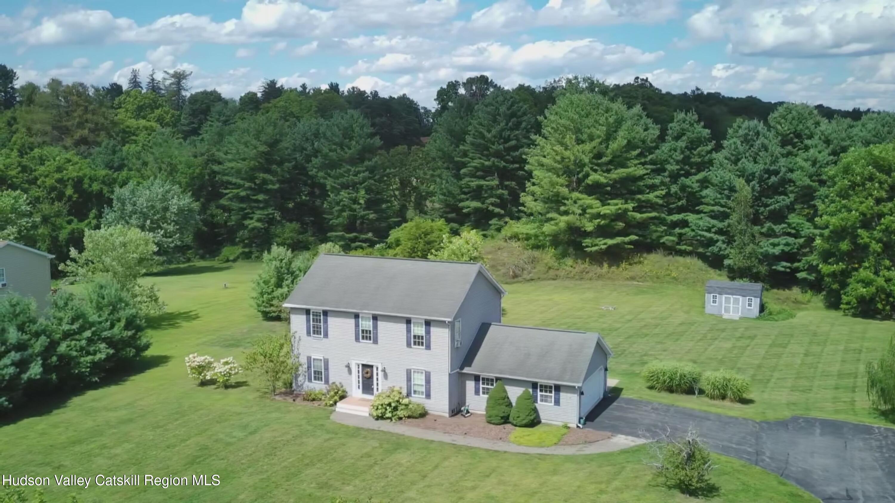 an aerial view of a house with porch yard basket ball court and trampoline