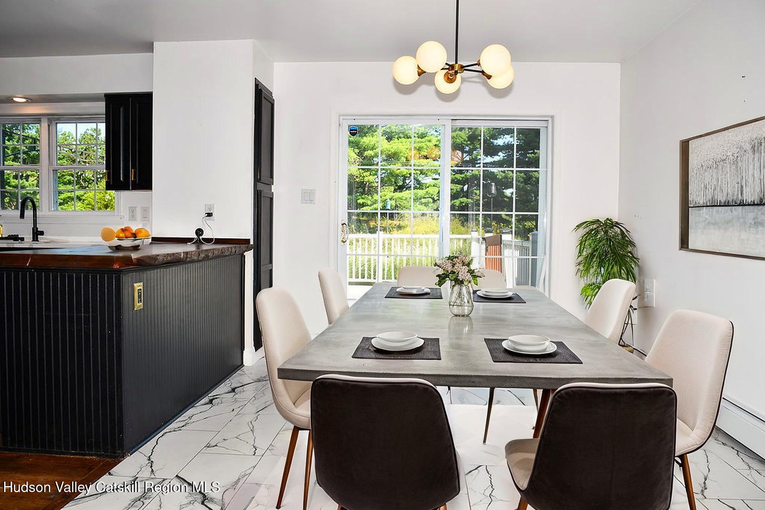 49 MacIntosh Drive Hudson, NY 12534 - Photo 13 of 39 a view of a dining room with furniture a chandelier and window