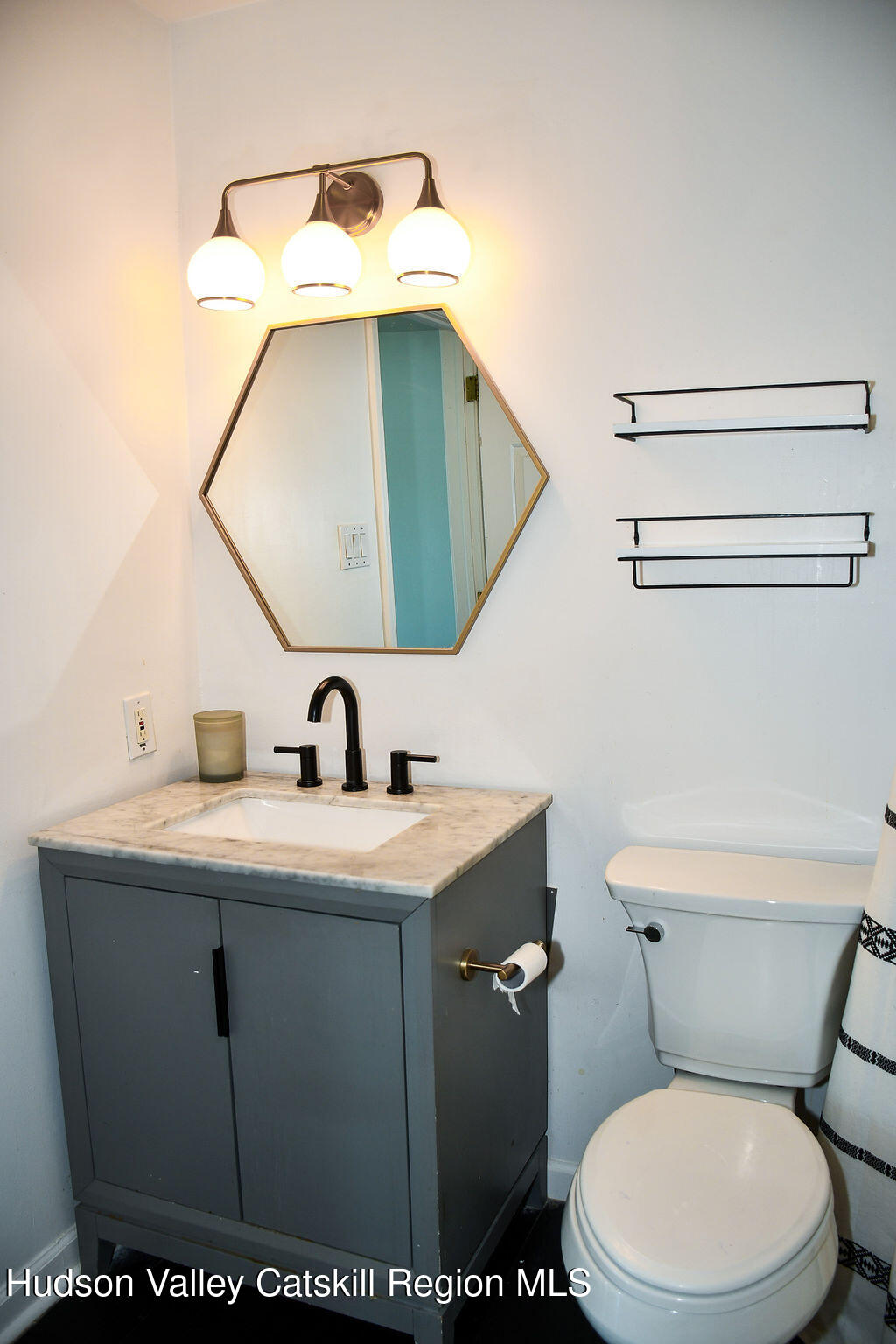 49 MacIntosh Drive Hudson, NY 12534 - Photo 19 of 39 a bathroom with a toilet sink and mirror