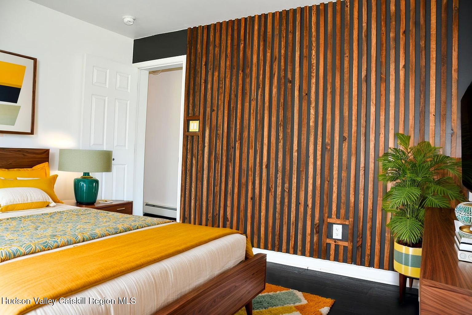 49 MacIntosh Drive Hudson, NY 12534 - Photo 21 of 39 a bedroom with a bed and a potted plant