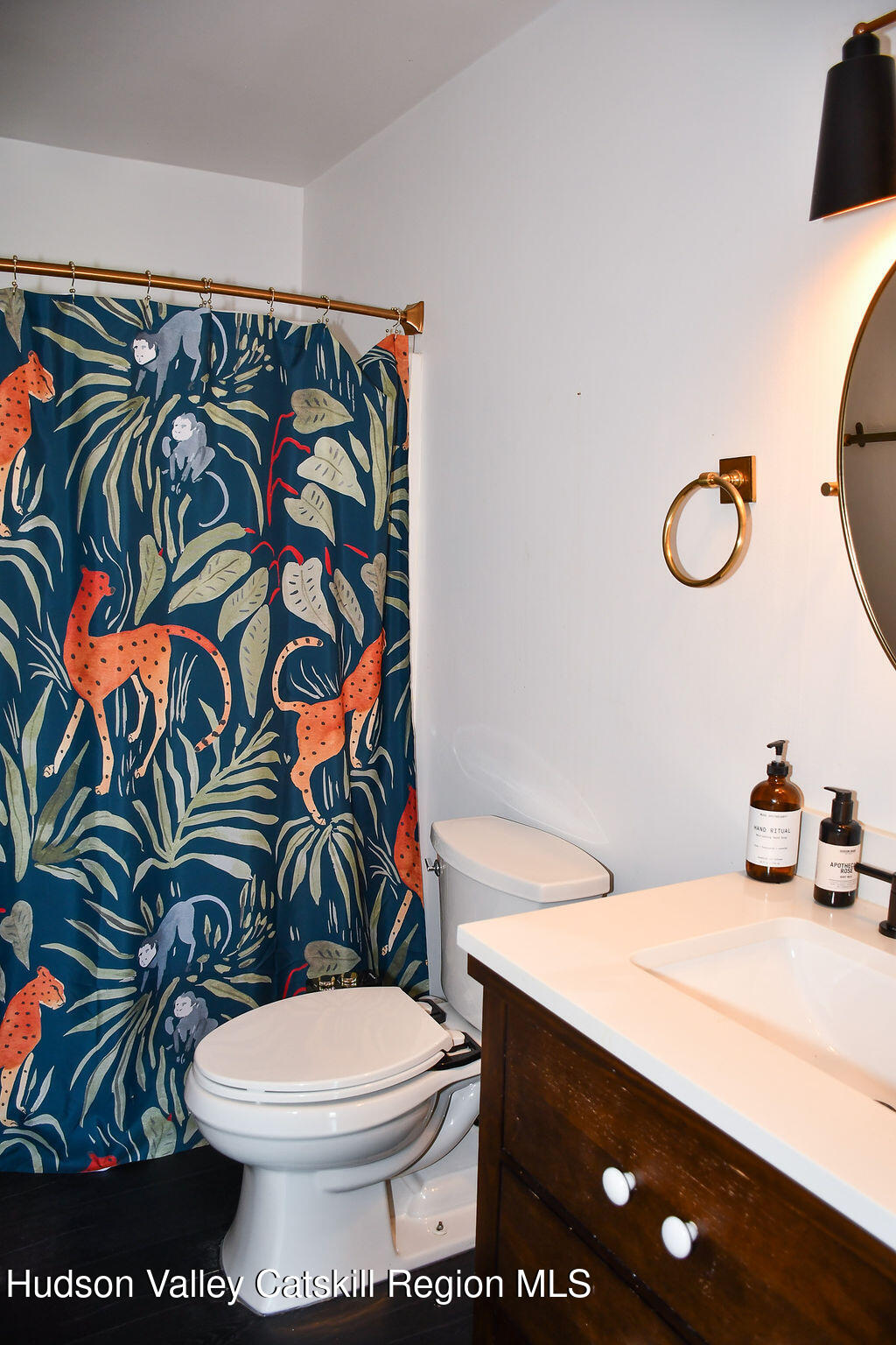 49 MacIntosh Drive Hudson, NY 12534 - Photo 26 of 39 a bathroom with a sink a toilet and shower curtain