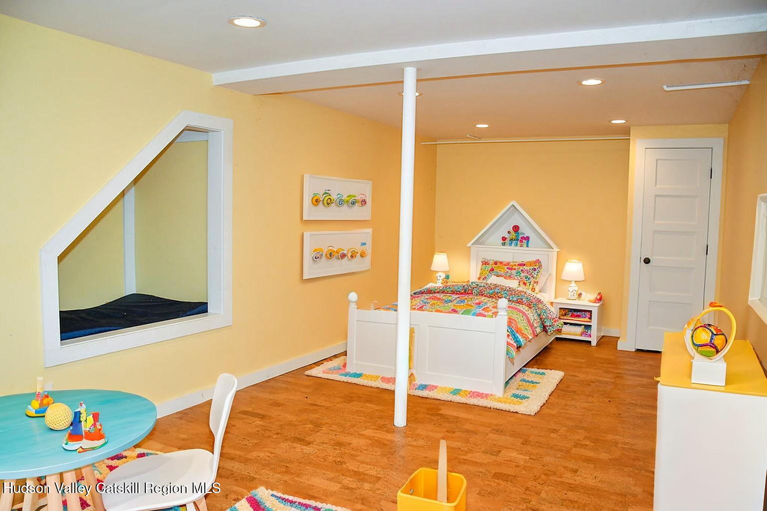 49 MacIntosh Drive Hudson, NY 12534 - Photo 30 of 39 a bedroom with a bed and wooden floor