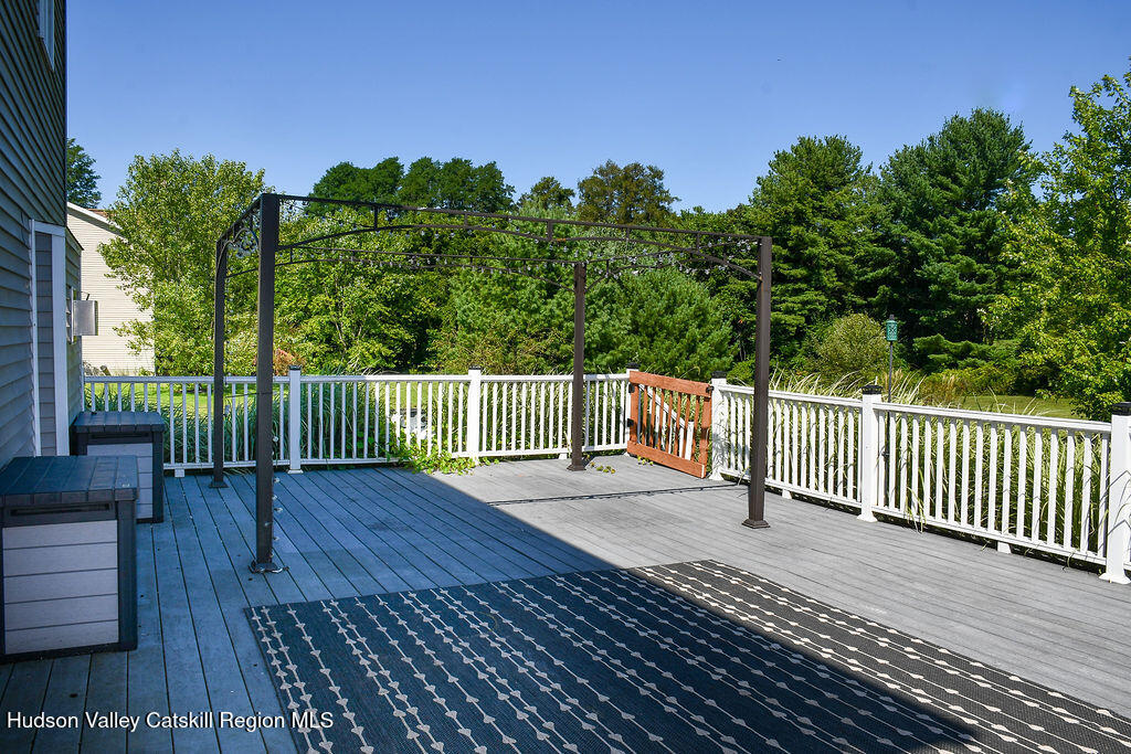 49 MacIntosh Drive Hudson, NY 12534 - Photo 3 of 39 a view of a deck with a floor to ceiling window and wooden fence