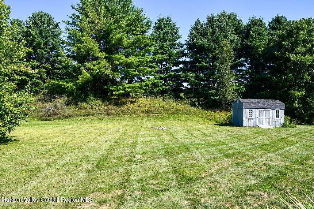 49 MacIntosh Drive Hudson, NY 12534 - Photo 5 of 39 a yellow building in the middle of a yard