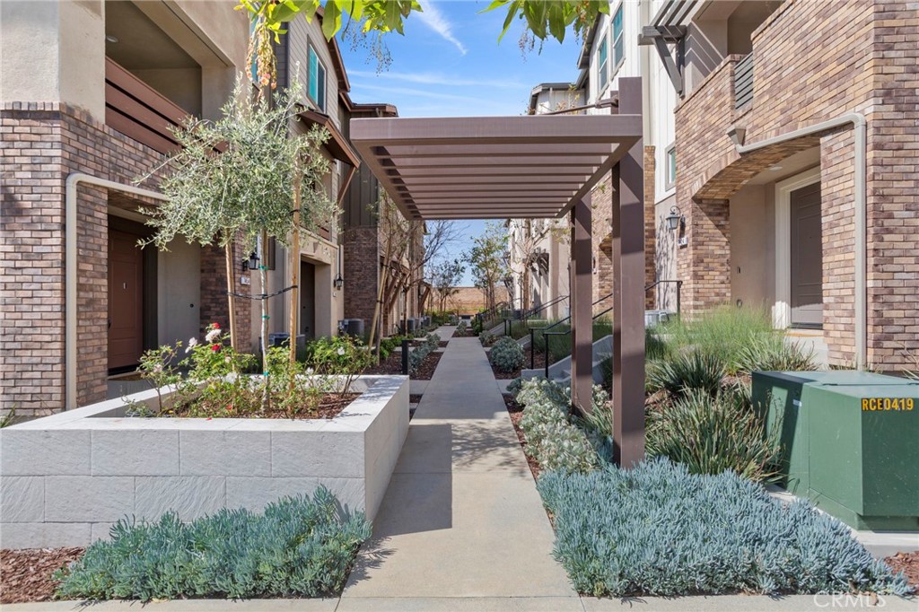 7434 Solstice Place Rancho Cucamonga, CA 91739 - Photo 1 of 1 a view of a pathway with house and garden