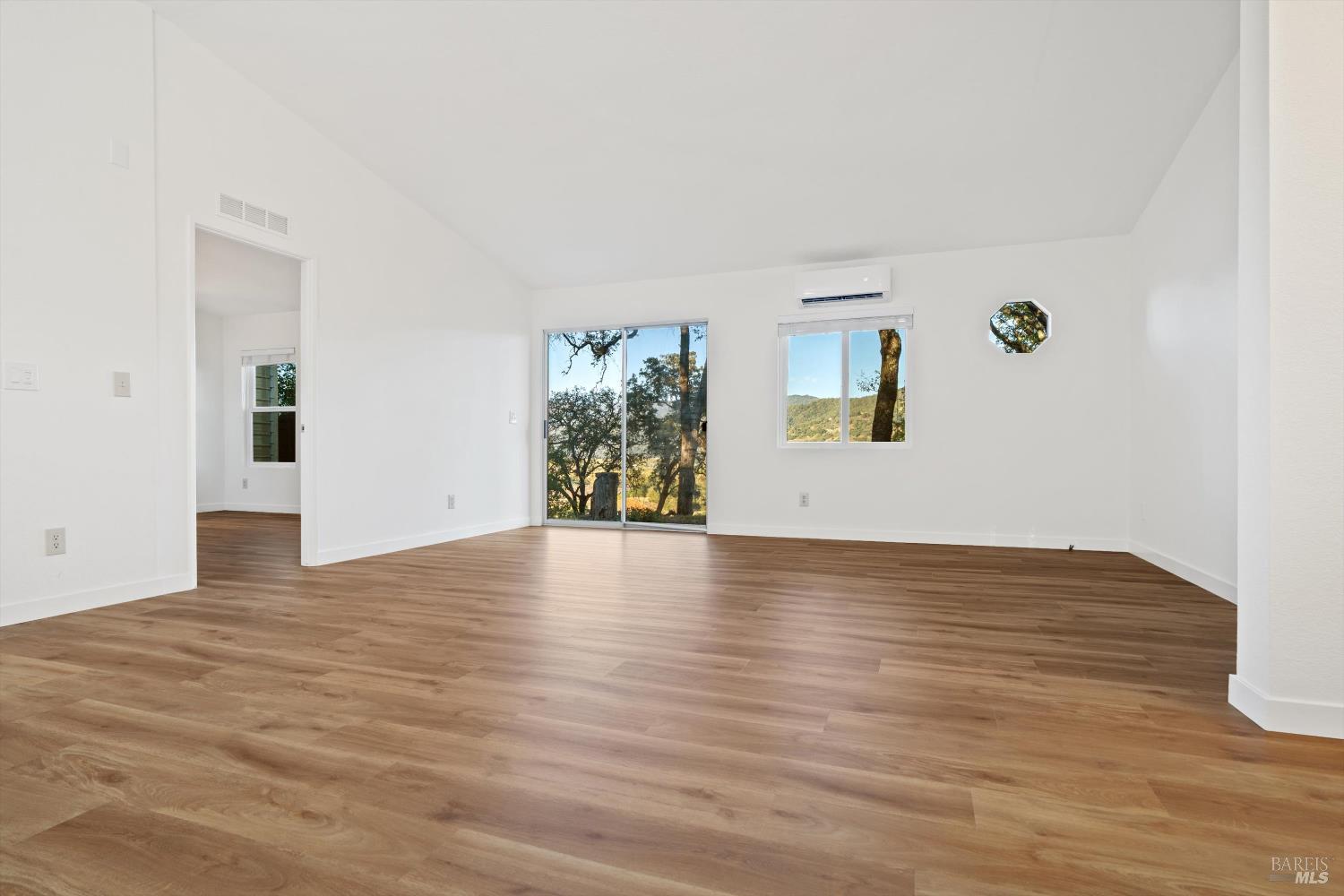 27770 Asti Road Cloverdale, CA 95425 - Photo 11 of 35 a view of an empty room with wooden floor and a window