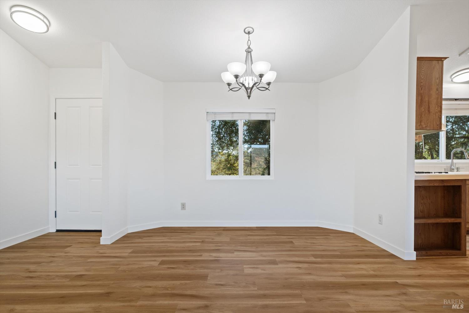27770 Asti Road Cloverdale, CA 95425 - Photo 13 of 35 a view of empty room with window and wooden floor