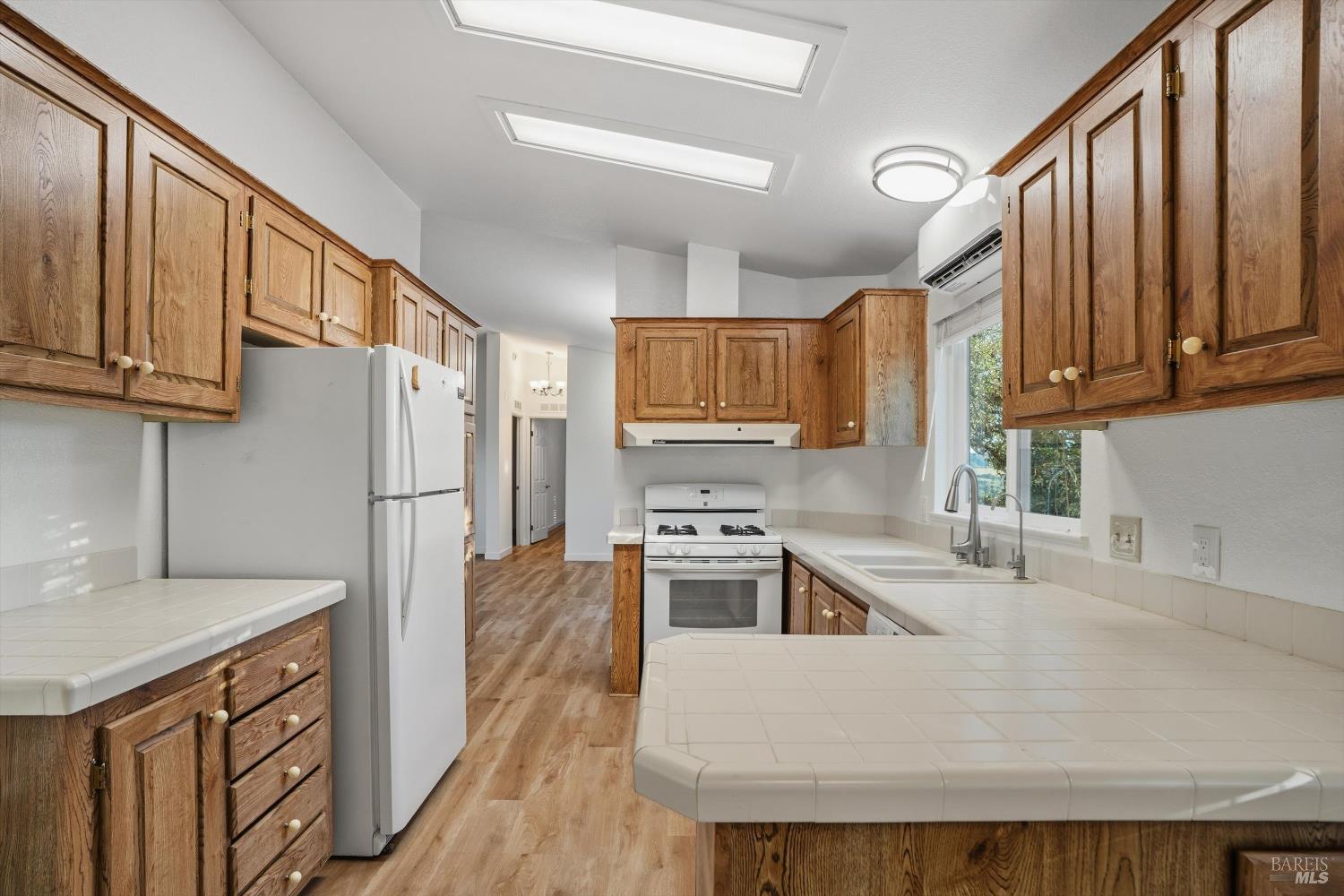 27770 Asti Road Cloverdale, CA 95425 - Photo 14 of 35 a kitchen with stainless steel appliances granite countertop a refrigerator a stove top oven a sink and dishwasher
