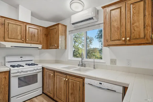 a kitchen with stainless steel appliances granite countertop a sink a stove and a microwave