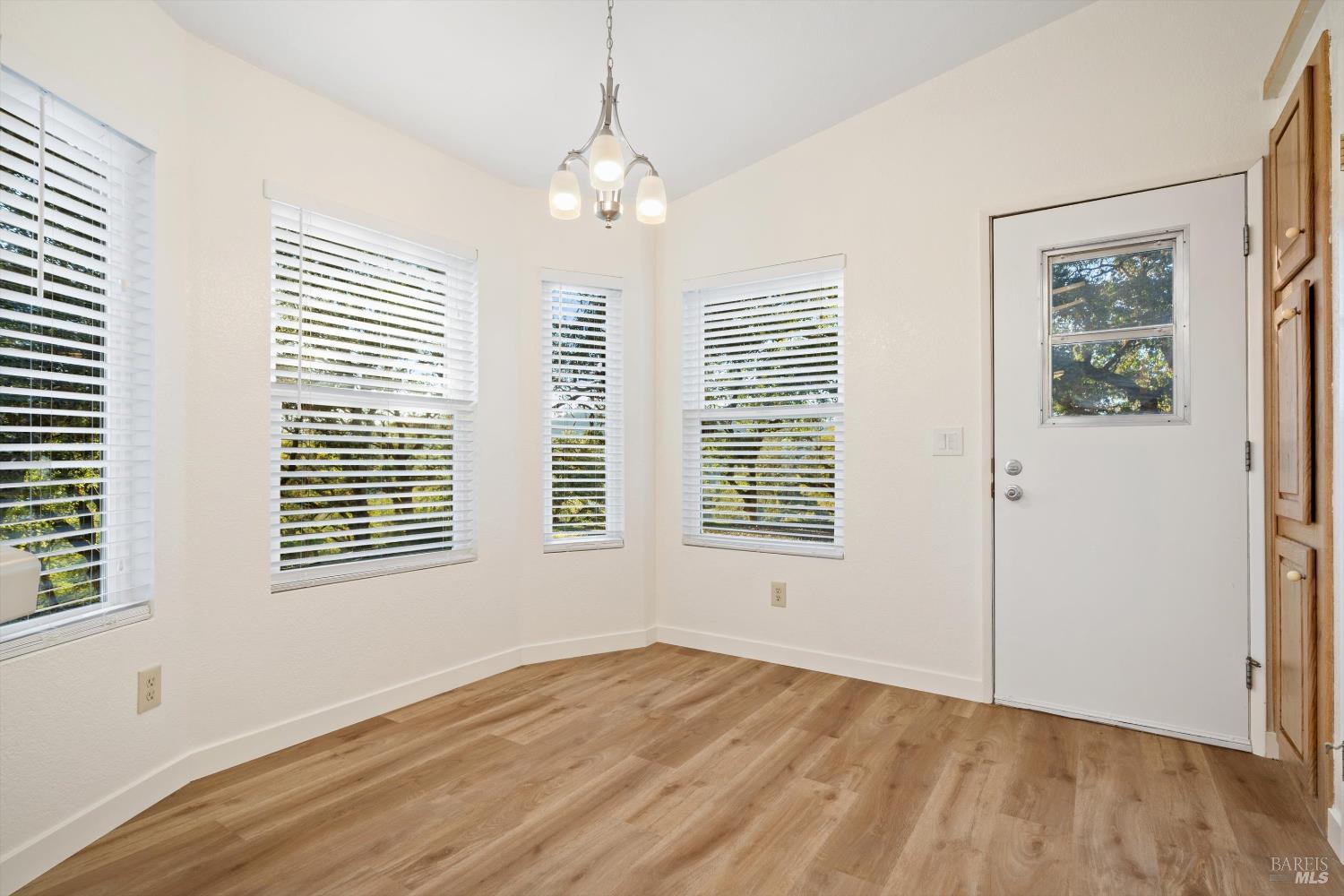 27770 Asti Road Cloverdale, CA 95425 - Photo 17 of 35 a view of an empty room with wooden floor and a window