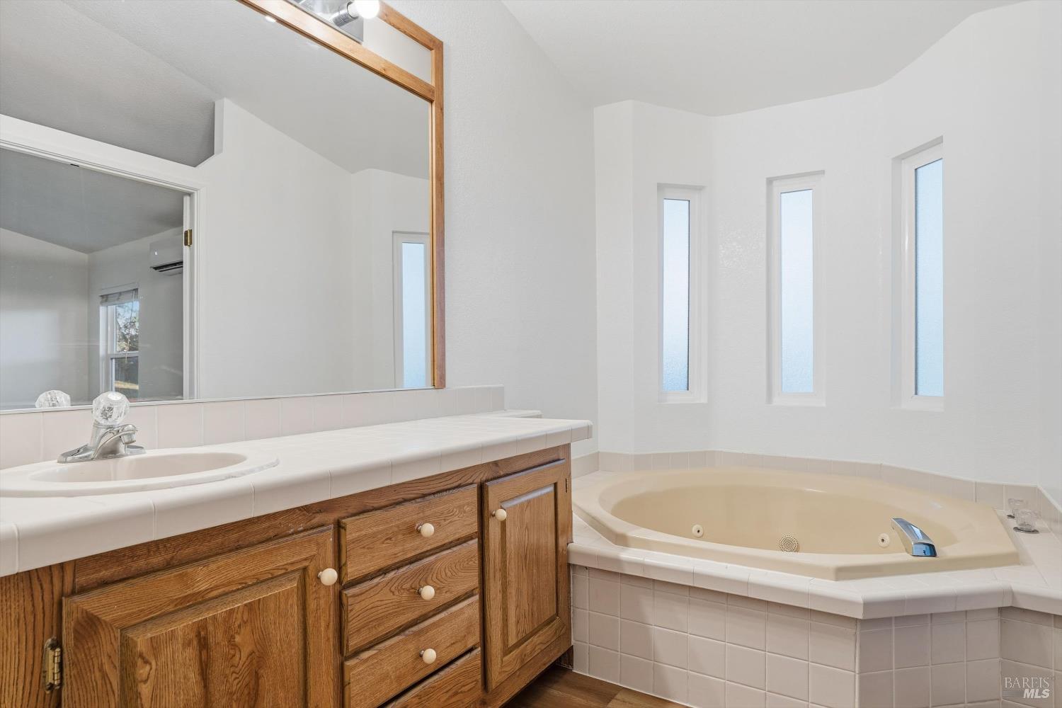 27770 Asti Road Cloverdale, CA 95425 - Photo 20 of 35 a bathroom with a tub sink and mirror