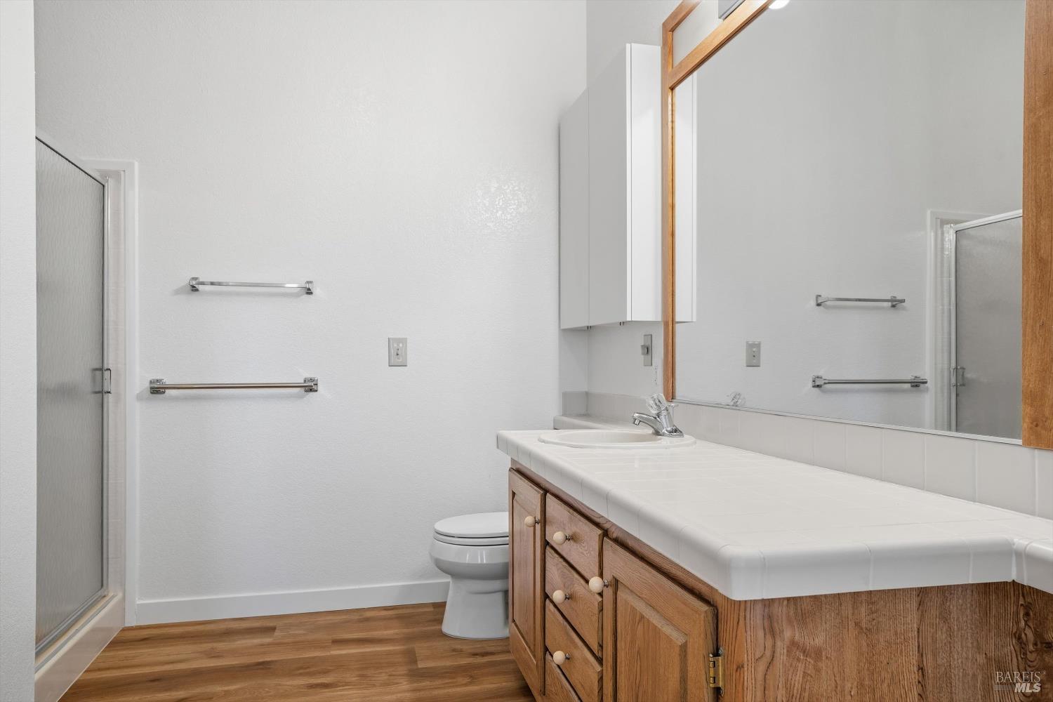 27770 Asti Road Cloverdale, CA 95425 - Photo 21 of 35 a bathroom with a sink a toilet and a mirror