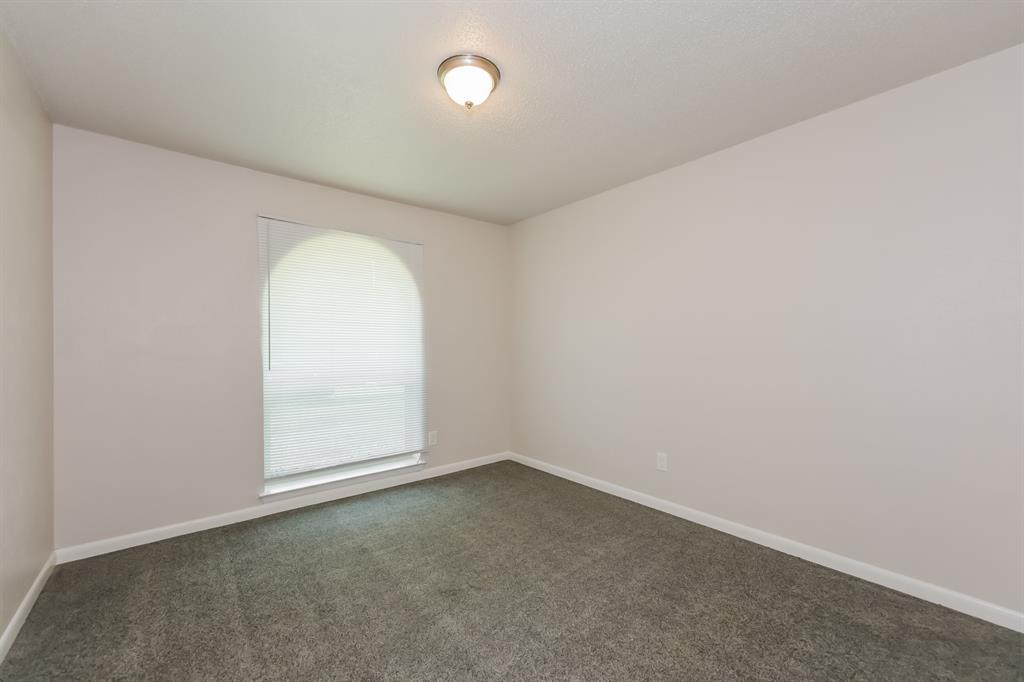 1816 Christopher Drive Fort Worth, TX 76140 - Photo 13 of 16 an empty room with a empty space and window