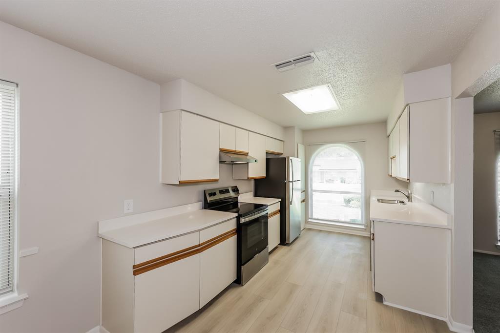 1816 Christopher Drive Fort Worth, TX 76140 - Photo 6 of 16 a kitchen with a sink stove and refrigerator