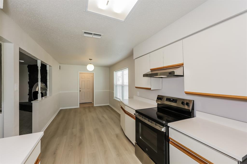 1816 Christopher Drive Fort Worth, TX 76140 - Photo 7 of 16 a kitchen with a stove and a refrigerator