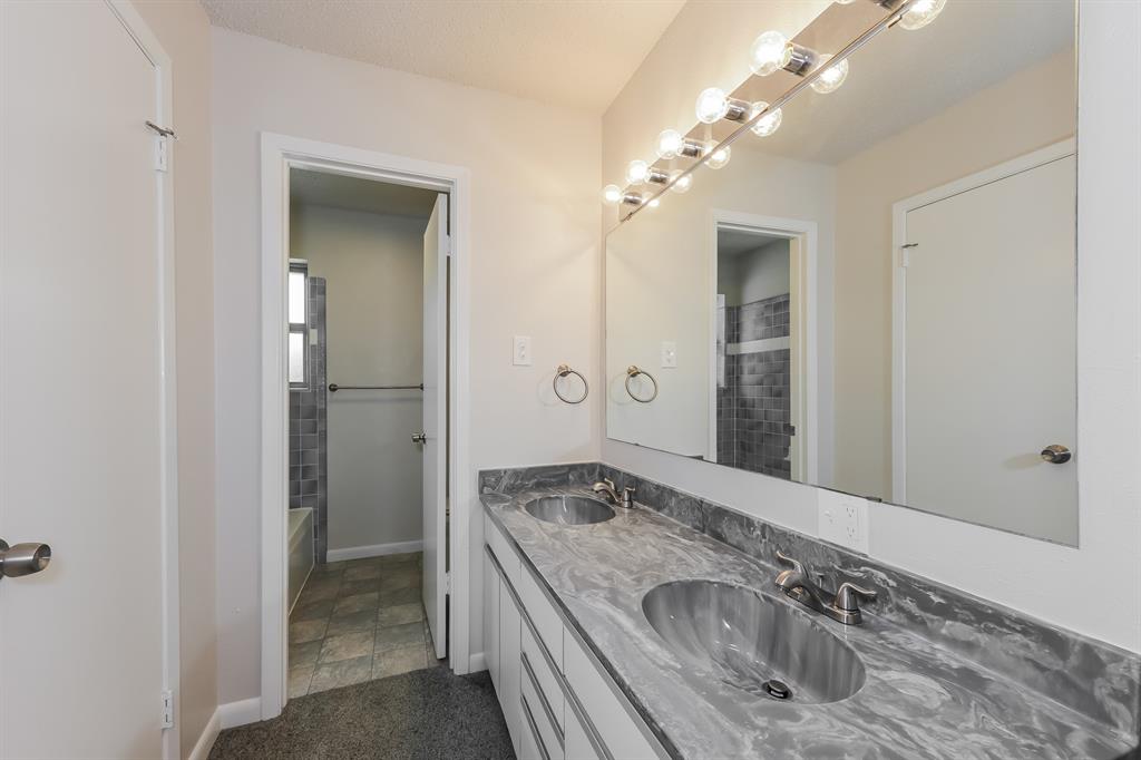 1816 Christopher Drive Fort Worth, TX 76140 - Photo 10 of 16 a bathroom with a granite countertop sink and a mirror